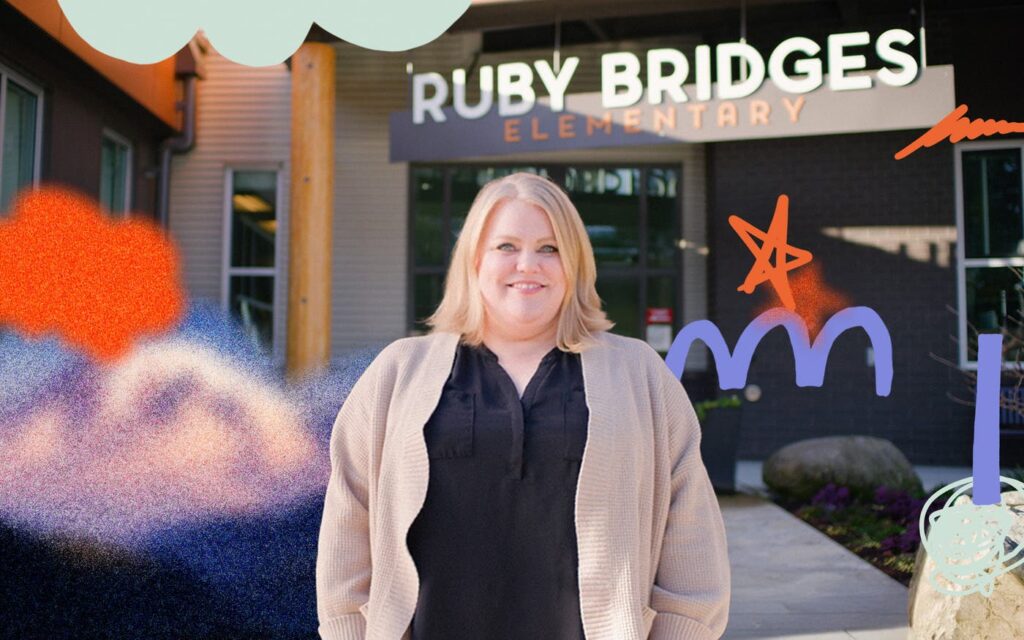 Women posing for a picture behind Ruby Bridges elementary