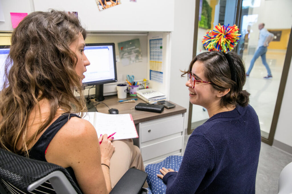 Two women in an office speaking.
