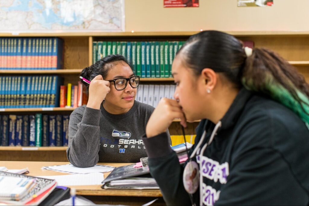 Two high schoolers in a school library