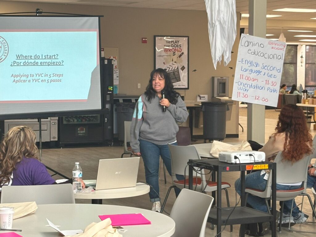 Women holding a microphone giving a presentation.